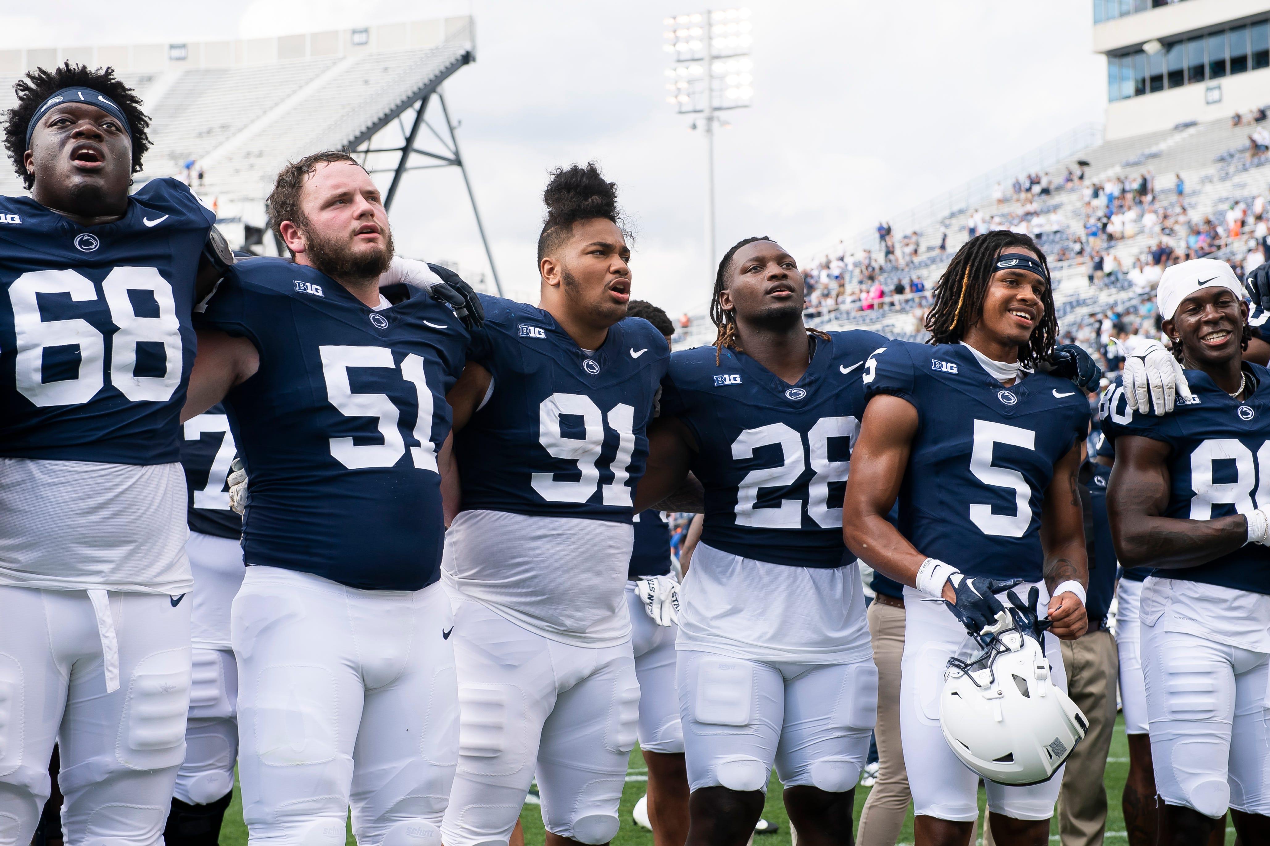 Penn State players singing the alma mater