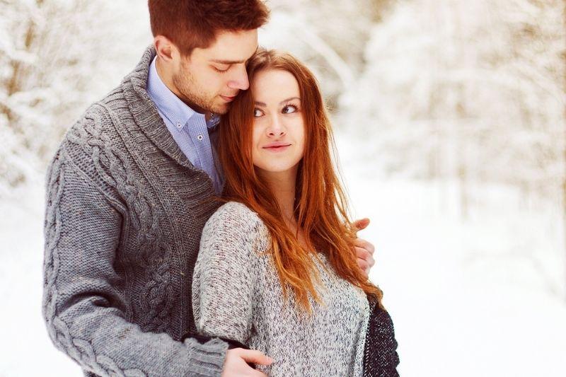 guy hugging woman standing outdoors during winter