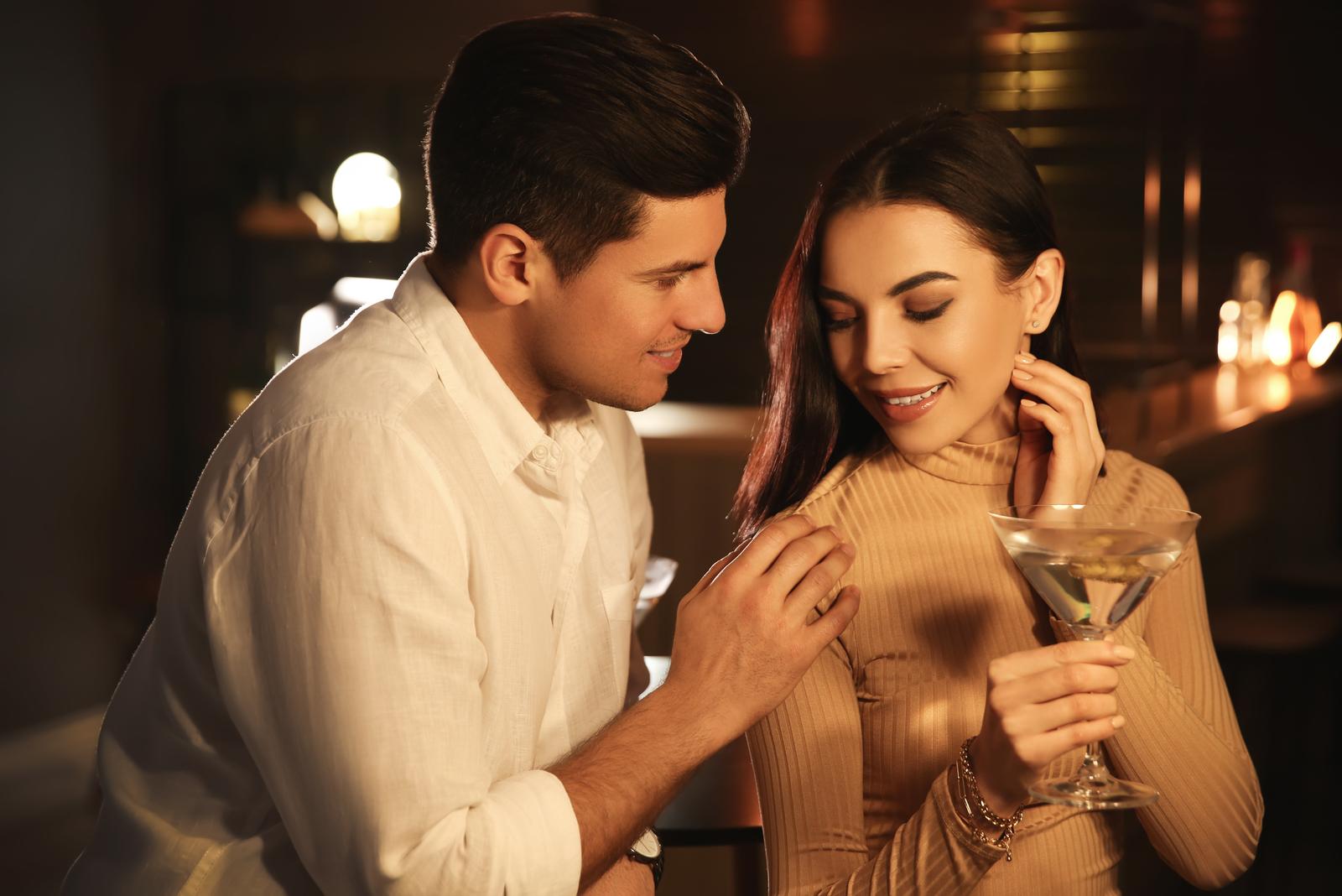 man flirting with woman in bar
